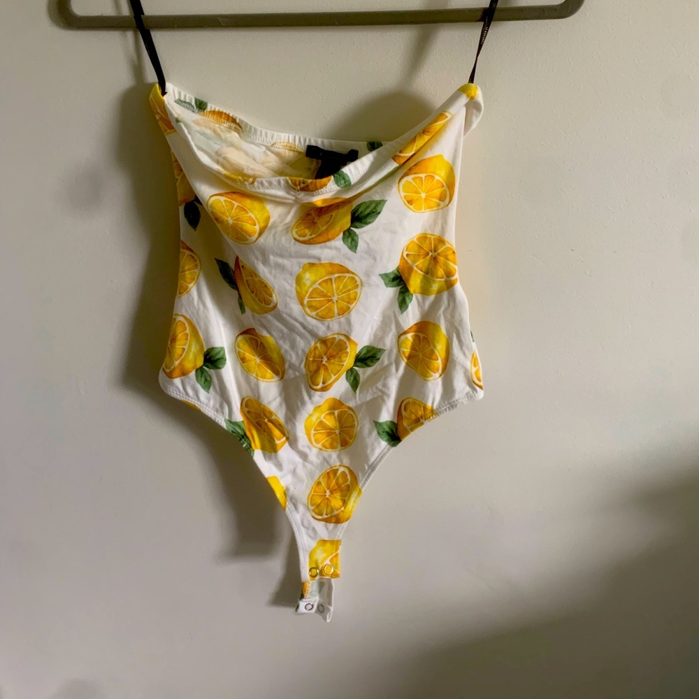 Strapless body suit buttons at bottom